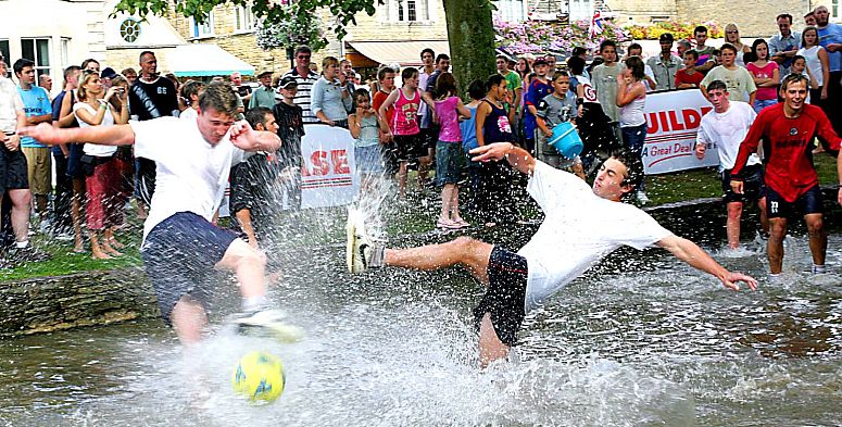 Players from Bourton Rovers FC take part in their annual August Bank Holiday derby fixture in the River Windrush where the "pitch" is always guaranteed to be waterlogged. Picture courtesy Cotswolds Conservation Board.